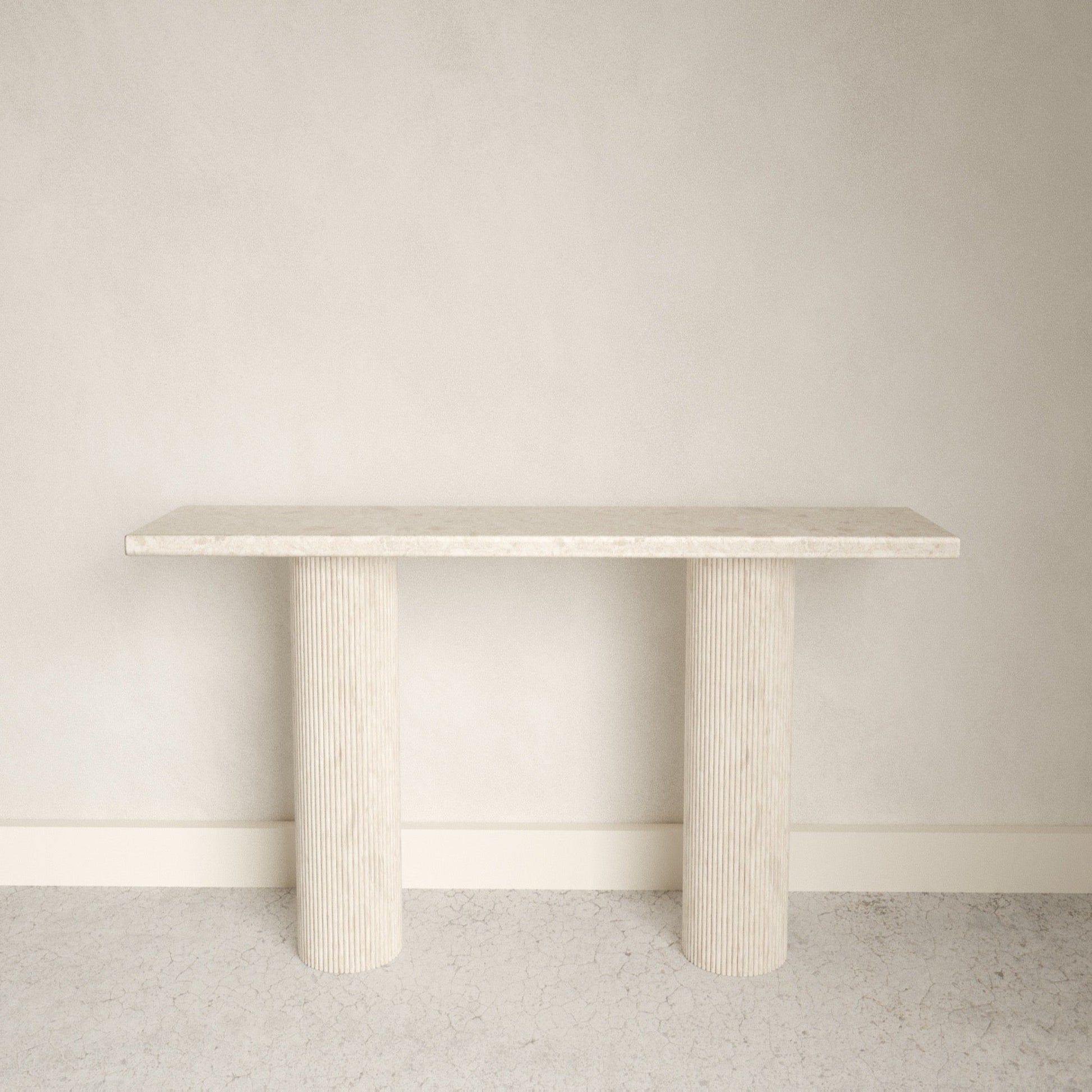 A smooth edged rectangular white Omani Marble marble console table with Roman style pillars.
